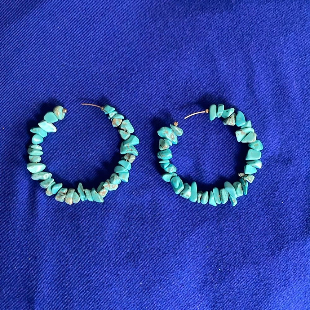 Turquoise hoop earrings .